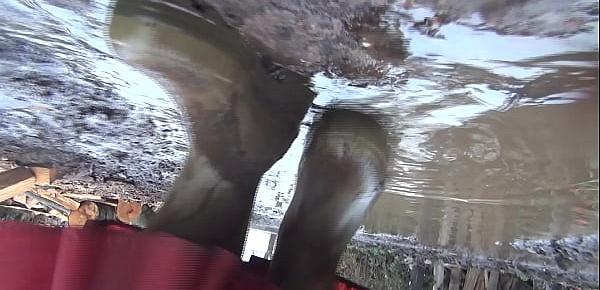  Brokenbitch filling the soles of her rubberboots with mud